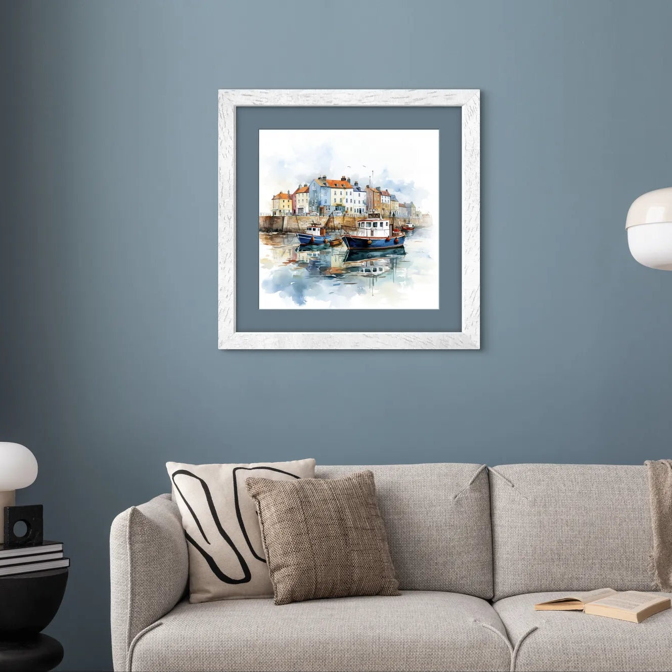 Watercolour painting of a coastal village with moored boats.