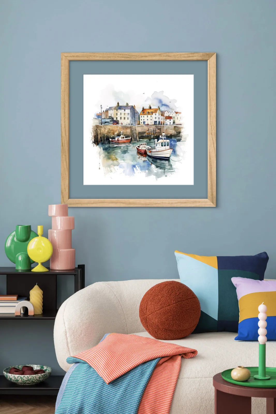 Watercolour painting of a harbour with boats and colourful houses.