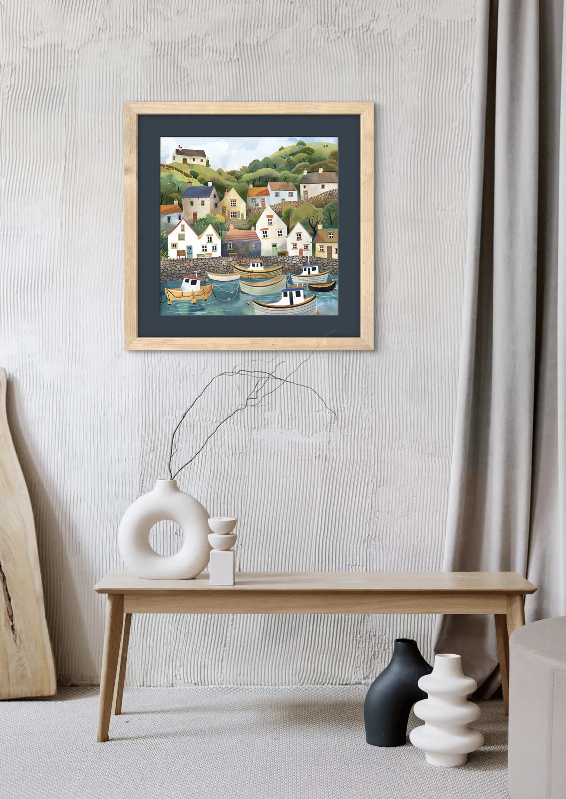 Artwork depicting a quaint coastal village with colourful houses and boats in a harbour.